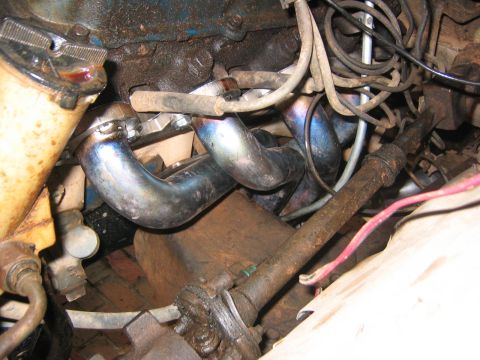 1979 Ford Bronco - Close-up view of engine exhaust headers, showing signs of heat and wear.