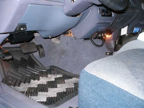 2001 Ford Crown Victoria - Interior view of the driver's side footwell, showing pedals and floor mats.