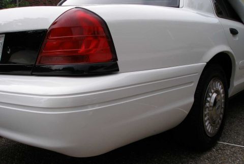 2001 Ford Crown Victoria - Rear view of a white 2001 Ford Crown Victoria, showing the taillight and quarter panel.