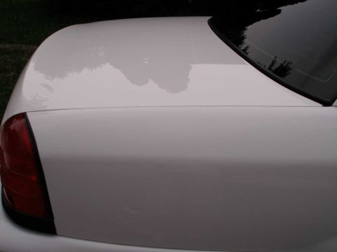 2001 Ford Crown Victoria - Rear view of a white 2001 Ford Crown Victoria showing the trunk lid and taillight assembly.