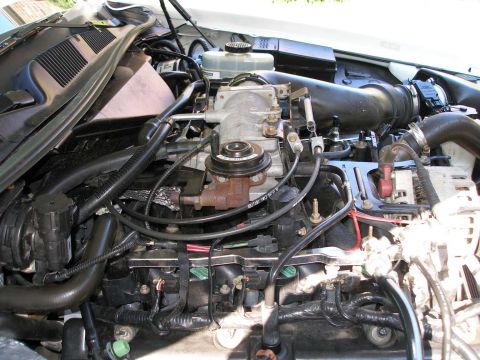 2001 Ford Crown Victoria - The engine compartment of a vehicle, with a focus on the fuel delivery and intake systems.