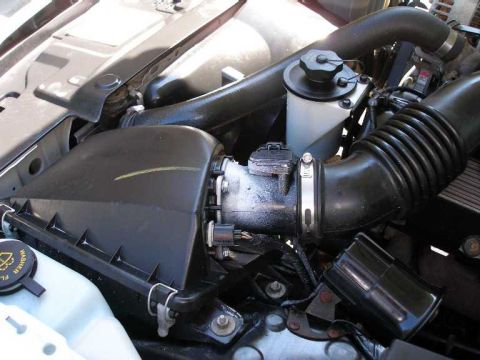 2001 Ford Crown Victoria - Close-up view of the engine bay in a 2001 Ford Crown Victoria, highlighting the air intake system.