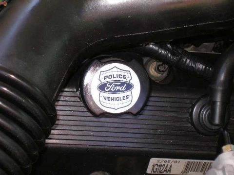 2001 Ford Crown Victoria - A close-up view of the engine bay shows a Ford Police Vehicles oil cap with a date stamp.
