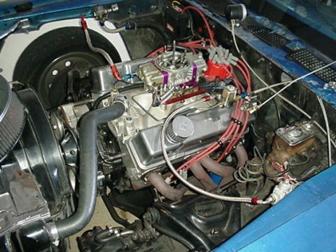 1978 Chevrolet Camaro - Close-up view of a modified V8 engine, a prominent carburetor and exhaust headers.