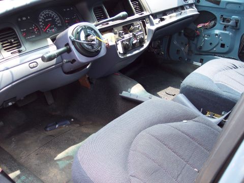 1991 Ford LTD Crown Victoria - The interior of a 1991 Ford Crown Victoria LTD shows the dashboard, steering column, and seats with some panels removed.
