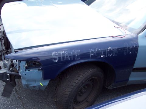 1991 Ford LTD Crown Victoria - Damaged 1991 Ford Crown Victoria LTD police car fender with visible 'STATE POLICE' lettering.