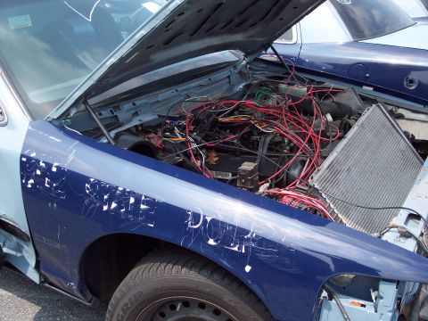 1991 Ford LTD Crown Victoria - Car's engine bay is exposed with wiring everywhere and the radiator removed from its position.