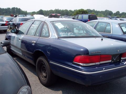 1991 Ford LTD Crown Victoria - A 1991 Ford Crown Victoria LTD is seen in a lot with other vehicles, handwritten notes on its windows.