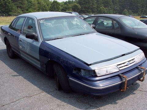 1991 Ford LTD Crown Victoria - This 1991 Ford Crown Victoria LTD police car has "STATE POLICE" text and a missing headlight.