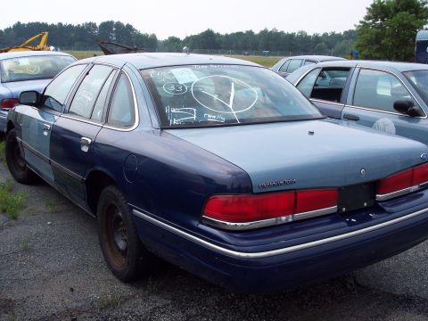 1991 Ford LTD Crown Victoria - Rear view of a 1991 Ford Crown Victoria LTD sedan, showing its taillights and trunk.