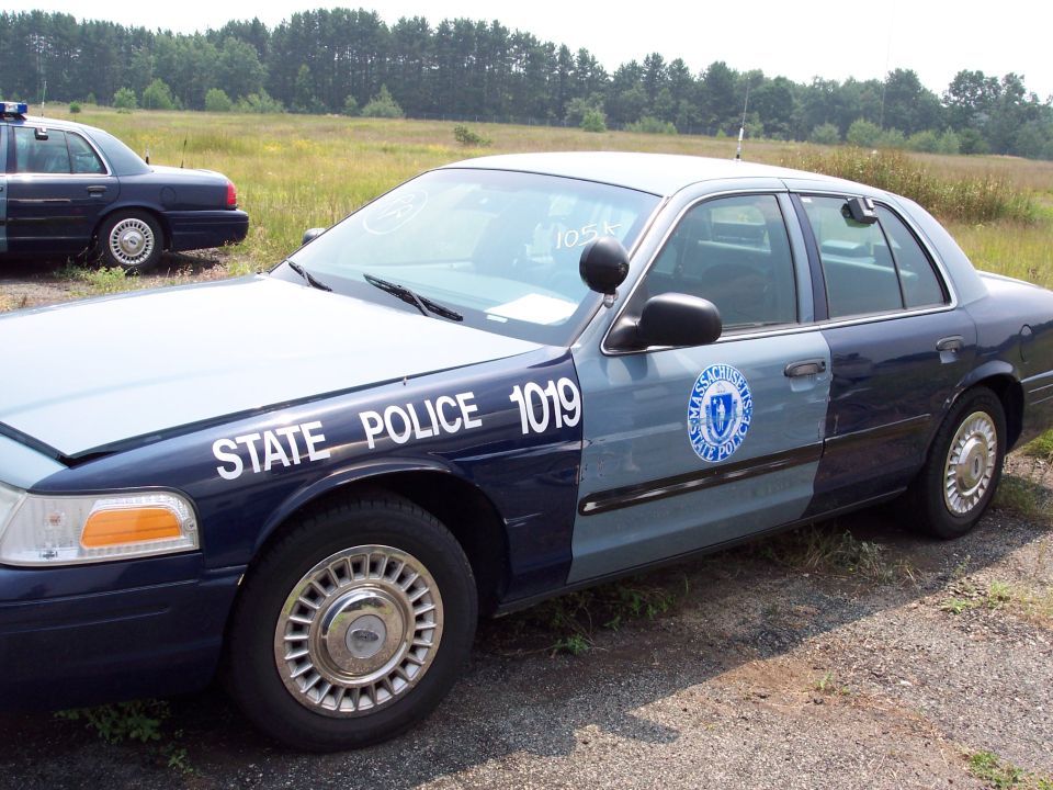 Massachusetts State Police car with number 1019 on the side. Another police car is visible behind it