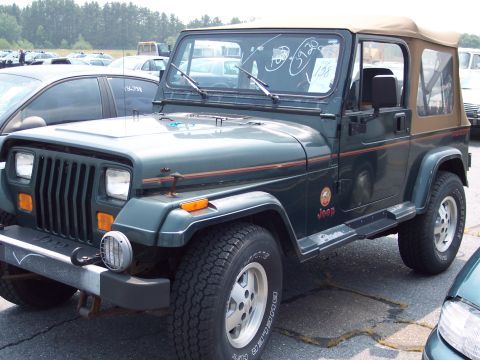 1991 Ford LTD Crown Victoria - Green Jeep Wrangler parked in an outdoor lot, with other vehicles visible in the background.