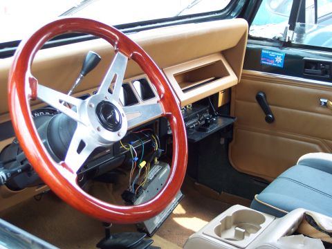 1991 Ford LTD Crown Victoria - The interior of a Jeep features a custom steering wheel and exposed wiring beneath the dashboard.