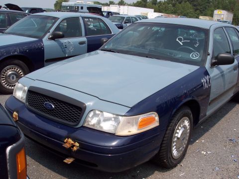 1991 Ford LTD Crown Victoria - A two-tone Ford Crown Victoria is seen in a vehicle lot, with another similar car parked behind it.