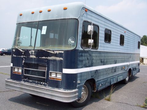 1991 Ford LTD Crown Victoria - This RV shows significant wear and tear, with peeling paint on the front and sides.