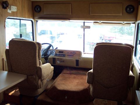 1991 Ford LTD Crown Victoria - Interior view of an RV showing the driver's area with seats and dashboard.