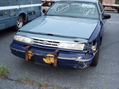 1991 Ford LTD Crown Victoria - This 1991 Ford Crown Victoria shows significant front-end damage and has handwritten notes on the windshield.