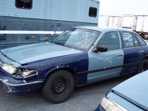 1991 Ford LTD Crown Victoria - This damaged Ford Crown Victoria has been marked with text indicating 'frame rot' and 'strip'.