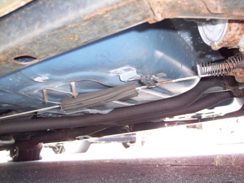 1991 Ford LTD Crown Victoria - Underbody view of a car, focusing on the fuel tank and exhaust system components.
