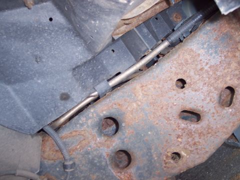 1991 Ford LTD Crown Victoria - The undercarriage of a vehicle shows significant rust on the frame and suspension components.