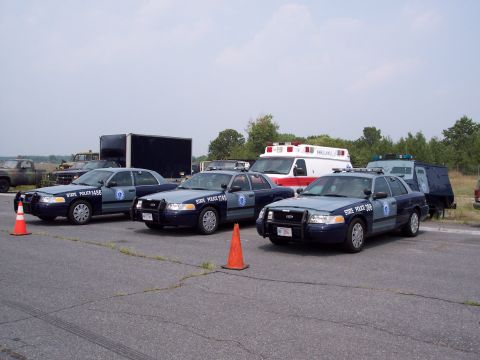 1991 Ford LTD Crown Victoria - Multiple state police vehicles and an ambulance are parked outdoors on a paved surface.