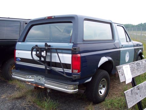 1991 Ford LTD Crown Victoria - This blue Ford Bronco has a two-tone paint job and a spare tire carrier mounted on the rear tailgate.