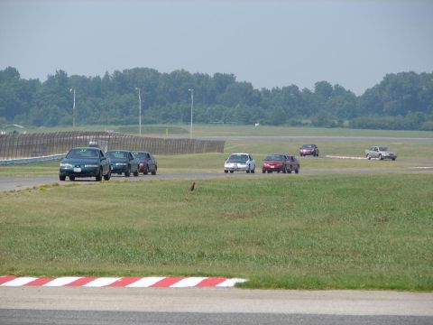 1992 Ford Taurus - Cars are seen on a racetrack during an event.