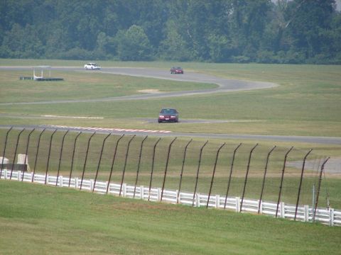 1992 Ford Taurus - Cars on a race track during a sunny day.