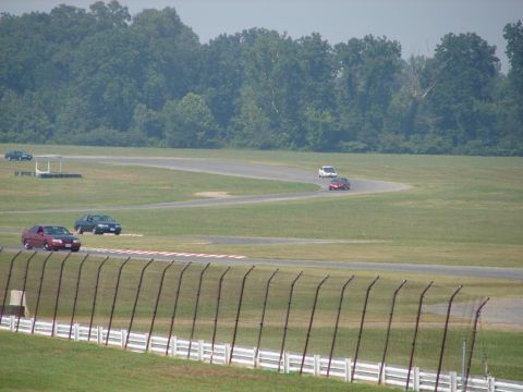1992 Ford Taurus - Cars are seen on a race track during what appears to be a track day event.