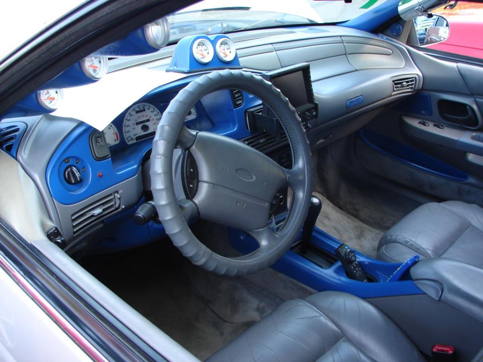 Interior of a 1992 Ford Taurus with blue trim and aftermarket gauges