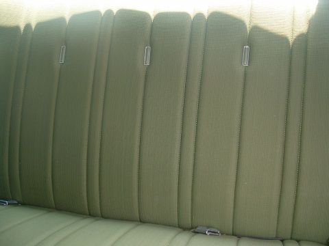 1975 Ford Torino - Interior view of a green patterned seat with vertical stitching and chrome accents.