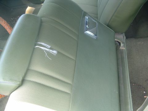 1975 Ford Torino - Interior view of a car seat with visible damage to the upholstery.