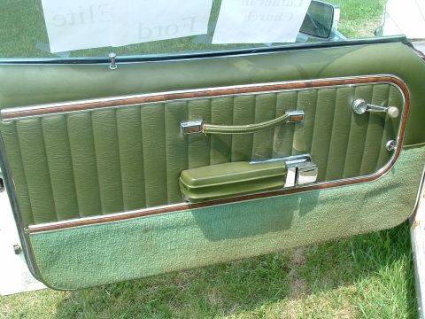 1975 Ford Torino - Interior door panel details of a vintage automobile, with a sign in the window.