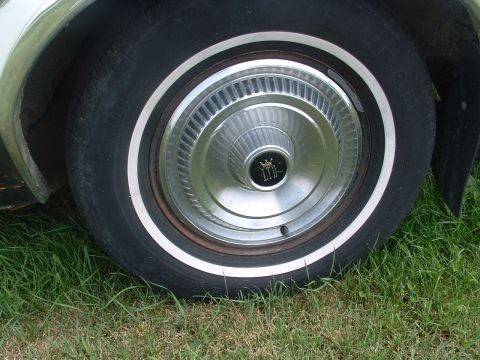 1975 Ford Torino - Close-up of a whitewall tire and a chrome hubcap an LTD emblem.