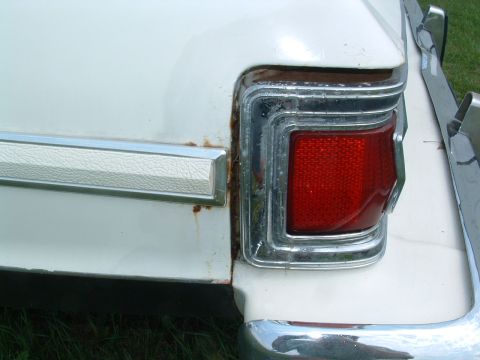 1975 Ford Torino - Close-up of the rear passenger side of a 1975 Ford Torino, showing rust around the taillight.