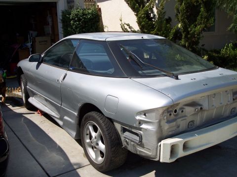 1993 Ford Probe - The rear of a silver coupe is shown with its bumper removed, revealing the car's internal structure.