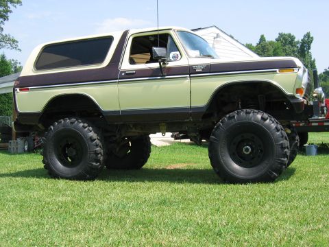 1992 Ford Mustang - This lifted Ford Bronco sits on a grassy lawn with a house in the background.