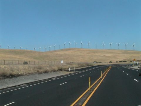 1971 Ford Bronco - View of a highway with wind turbines lining a hill in the background.