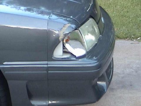 1989 Ford Mustang - Front passenger side fender and headlight assembly of a 1989 Ford Mustang showing damage.