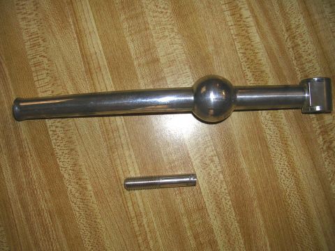 1996 Ford Probe - A close-up view of a metal gear shifter and a separate bolt resting on a wooden surface.
