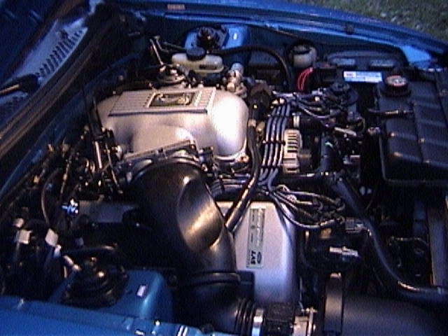 Engine bay with silver intake manifold and black hoses
