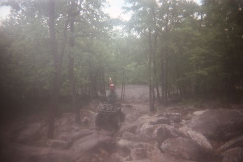 2004 Honda TRX 450 FM - Riding an ATV through a wooded area with many rocks and mud.