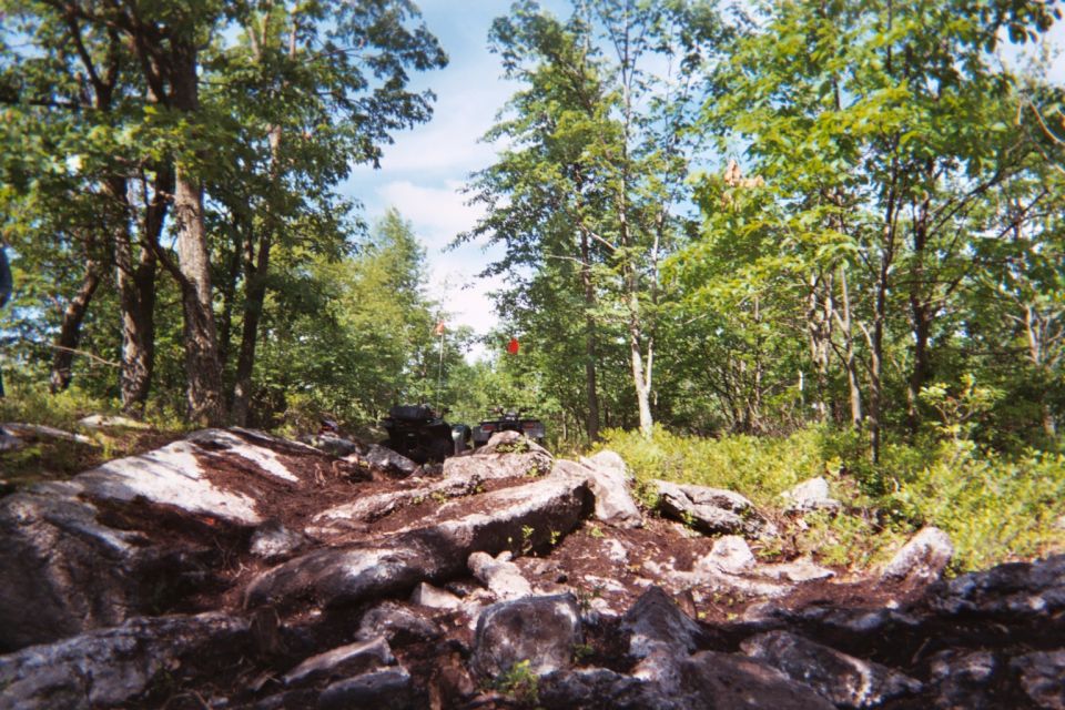All-terrain vehicle on a rocky, wooded trail