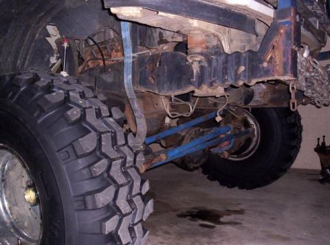 1995 Ford Bronco - Close-up view of a vehicle's rear axle and suspension system, highlighting its off-road modifications and condition.