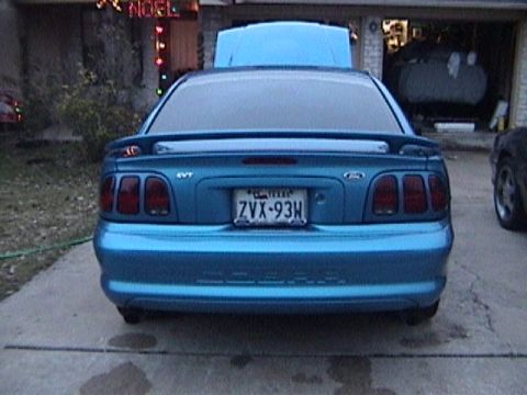 1989 Ford Mustang - Rear view of a blue Ford Mustang, possibly an SVT model, with its hood up.