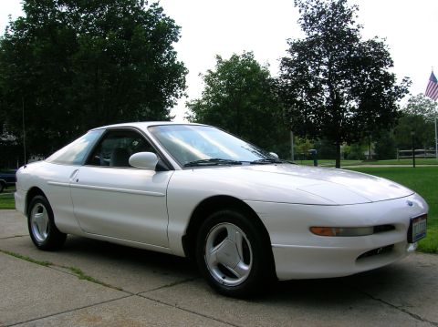 1997 Ford Probe - A white 1997 Ford Probe is parked on a driveway, seen from the front three-quarter angle.