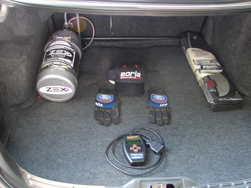 Car trunk with ZEX nitrous bottle, Borla hat, Ford gloves, and SCT tuning device