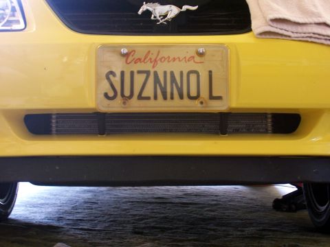 2002 Ford Mustang - Front view of a yellow 2002 Ford Mustang, a California license plate and an aftermarket intercooler.