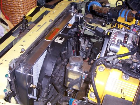 2002 Ford Mustang - Close-up of an engine bay with a prominent radiator and alternator. A "4.6L" badge is visible.
