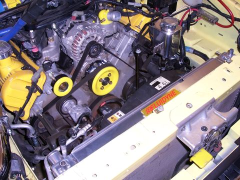 2002 Ford Mustang - Close-up view of a modified engine bay a 4.6L engine with yellow performance parts.